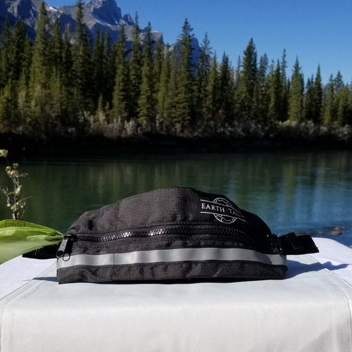 Little helper pouch shown on display table in front of river and trees